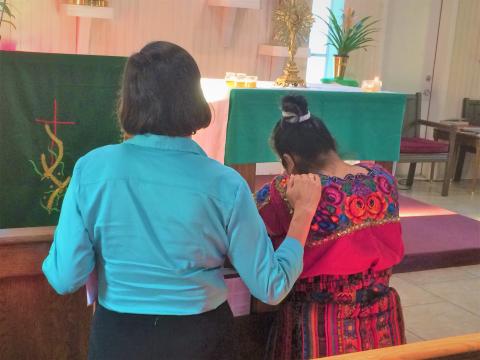 Sr. Gabriela Ramirez prays for and comforts a woman affected by the 2019 raid in Morton, Mississippi. (Sr. María Elena Méndez)